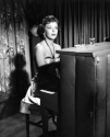 Ida Lupino with Wilardy rhinestone handbag on piano